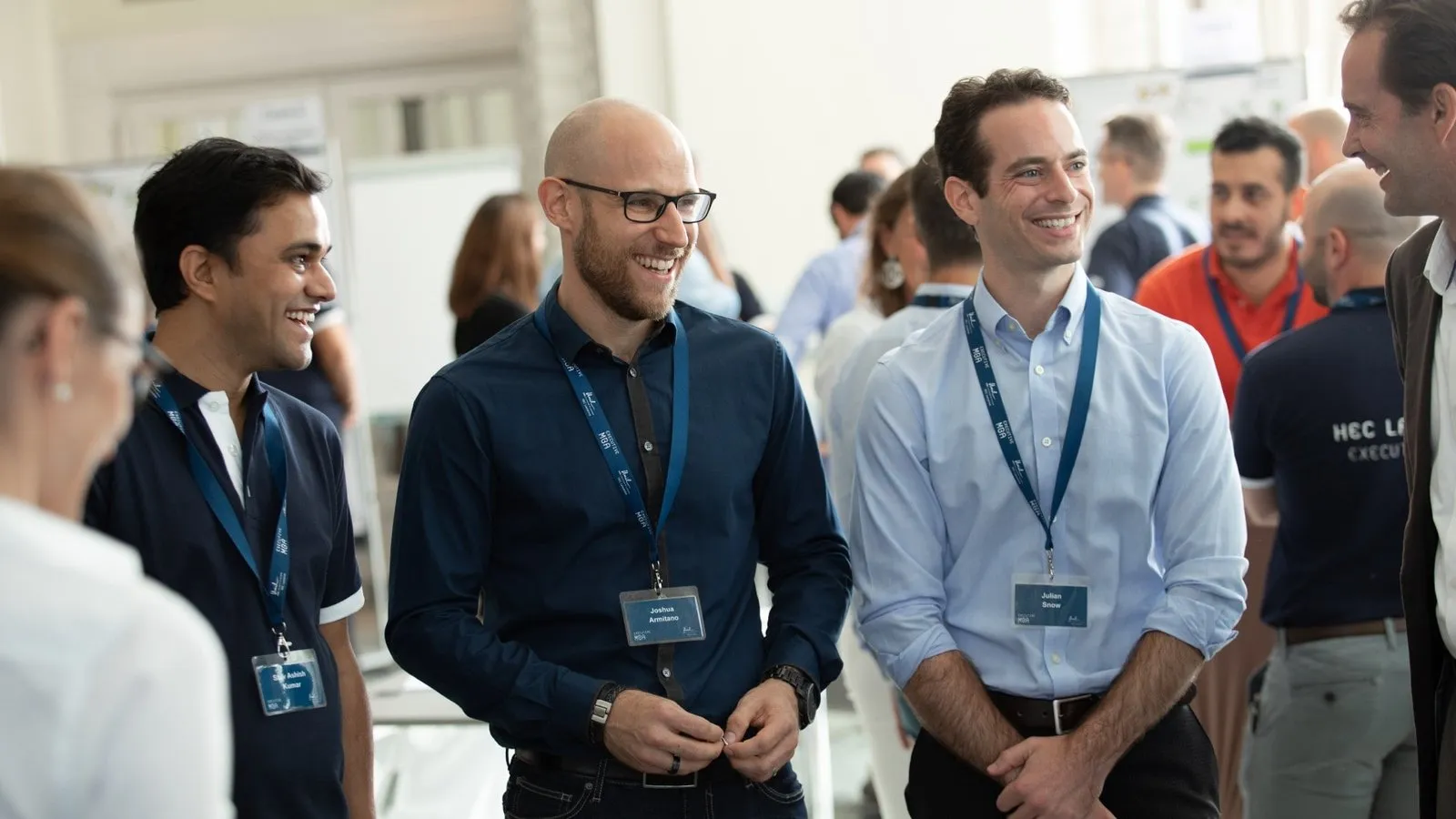 Smiling EMBA participants chatting during the introduction week