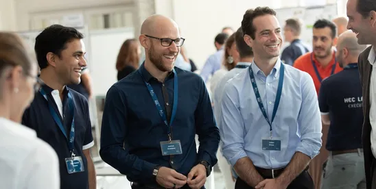 Smiling EMBA participants chatting during the introduction week