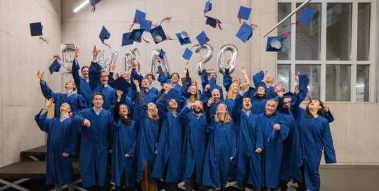 HEC Lausanne Executive MBA graduates throwing their caps in the air